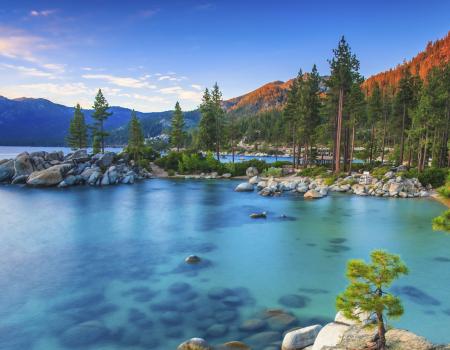 view of lake from large boulder rocks on the side of the lake