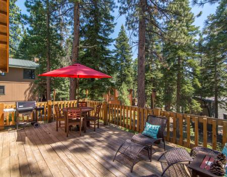 outdoor dining table with large red umbrella