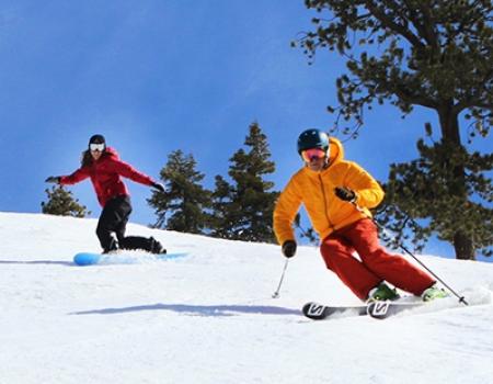 two people skiing down the mountain